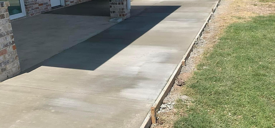 Completed patio concrete meeting the lawn edge